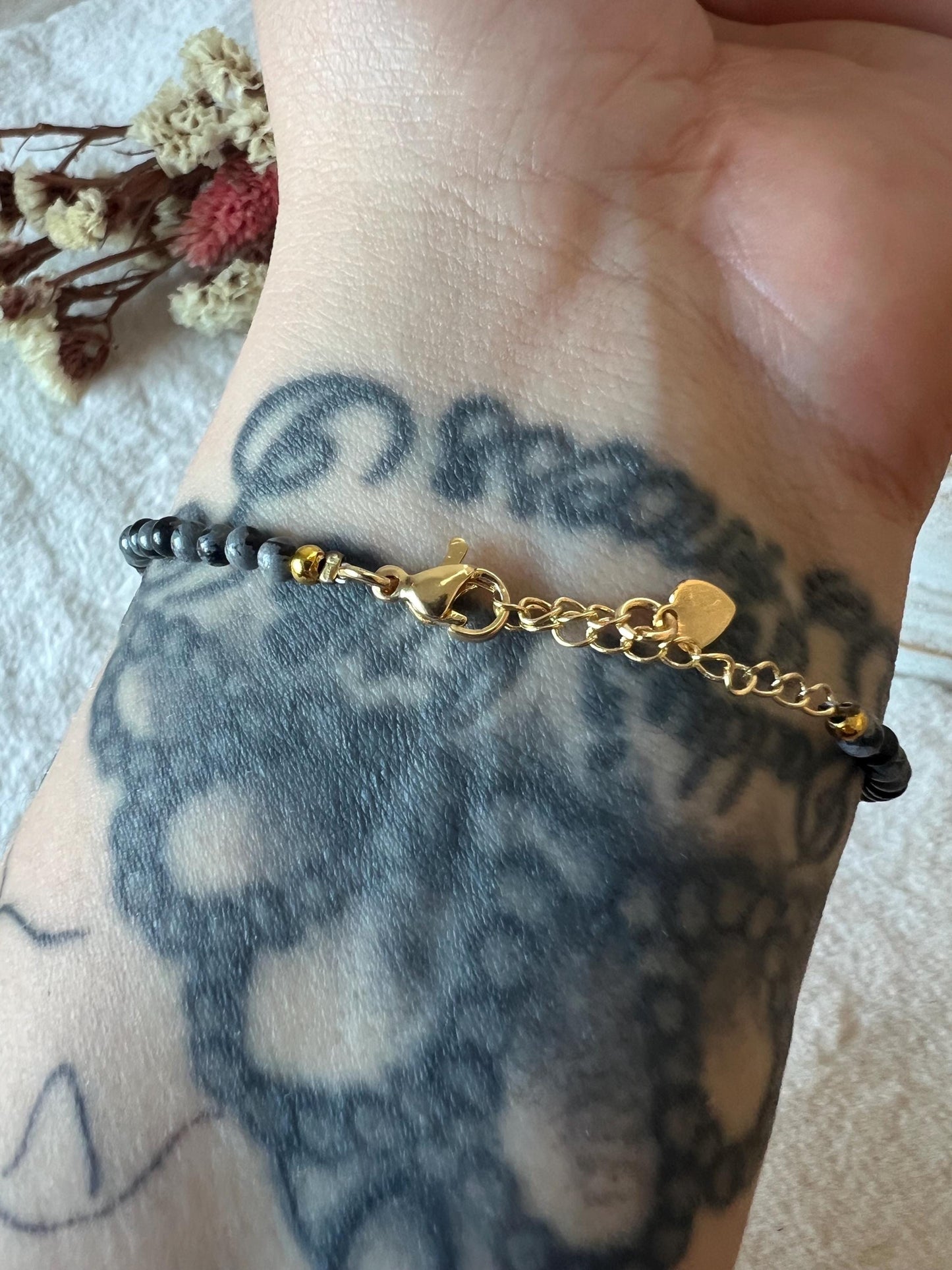 Schneeflocken Obsidian Armband goldfarben grössenverstellbar